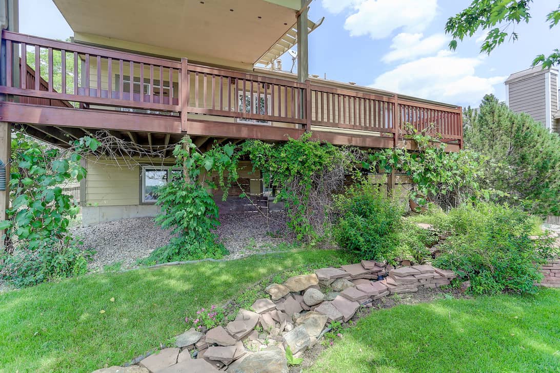 Exposed foundation and sloped yard.